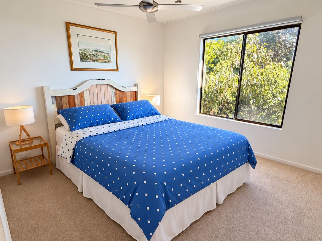 The Valley Room with queen bed and garden window at Sandy Feet Retreat